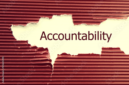 Accountability word written under torn paper. photo