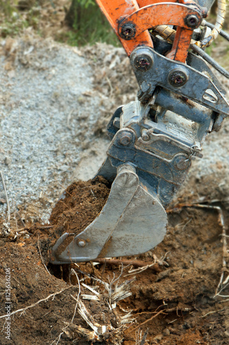 Closeup of an excavator digging soil from the ground.