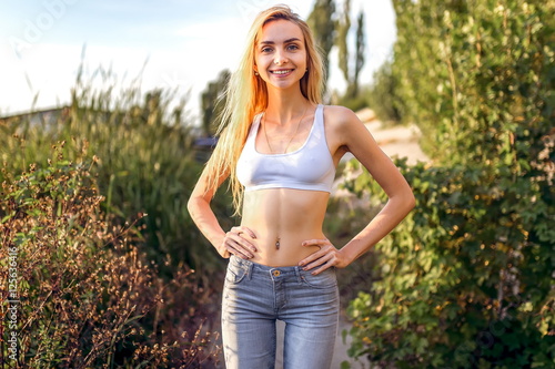 skinny girl in a short white top photo