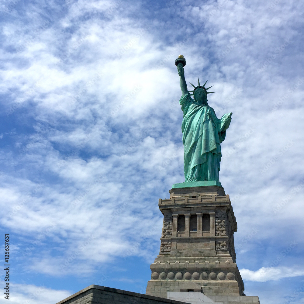 Statue of Liberty with cloudy blue sky, New York
