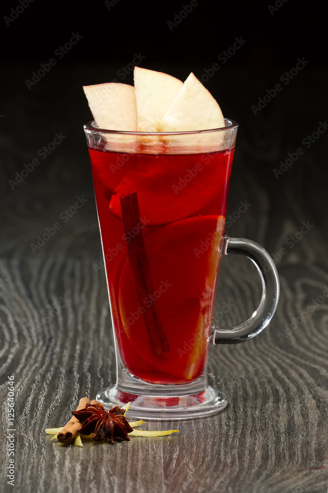 Glass of hot fruit tea on wooden table Glass of hot fruit tea on wooden table