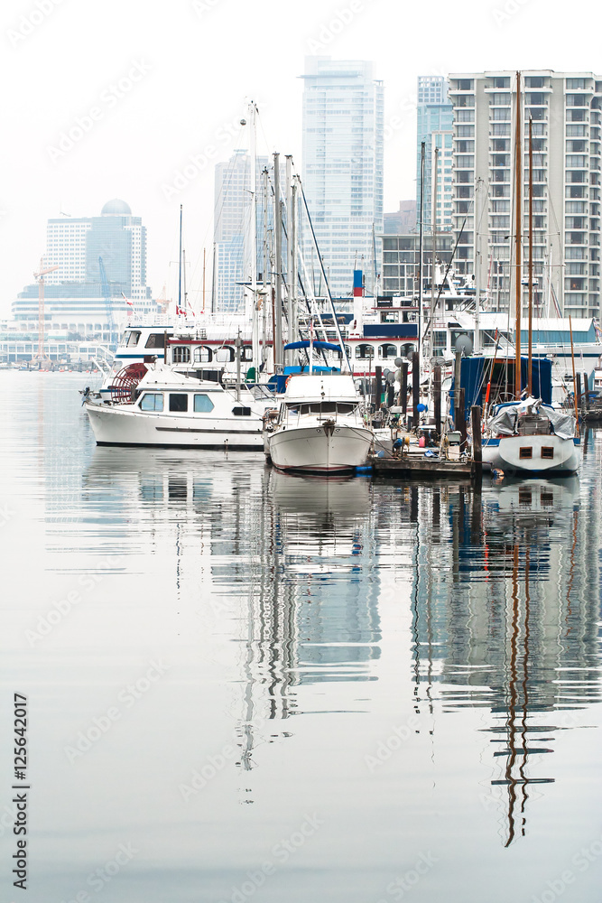 boats and yachts in a misty day in coal harbour marina