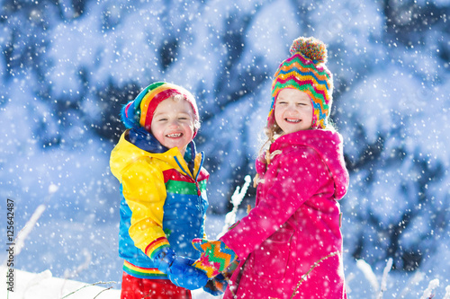 Children playing in snowy winter park