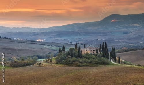 red sunset in Tuscany with old villa