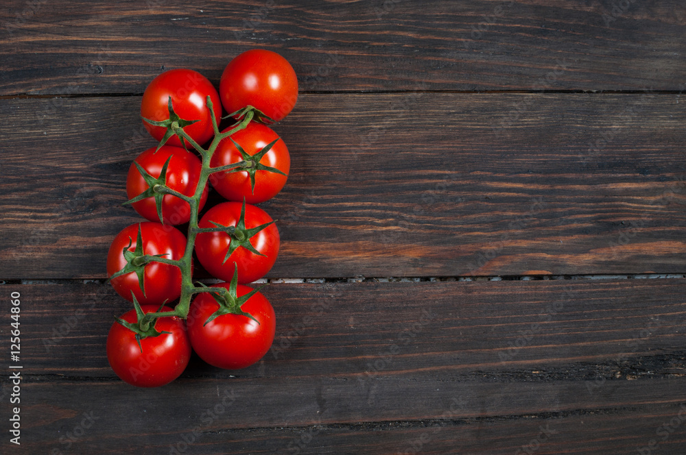 Fresh cherry tomatoes on wood background. Fresh cherry tomatoes on wood background.