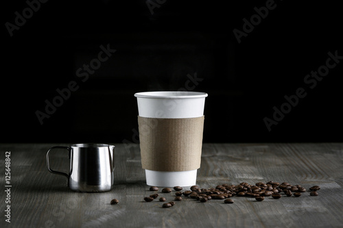 Coffee drink in a white cup, on a wooden background