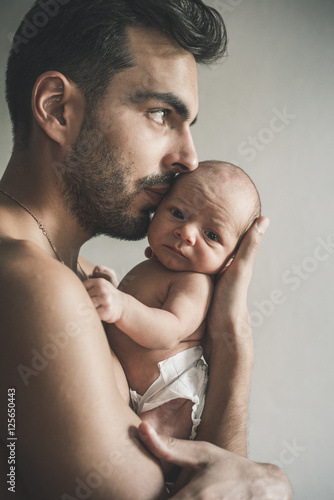 Portrait of loving father with baby at home. Sepia Toned