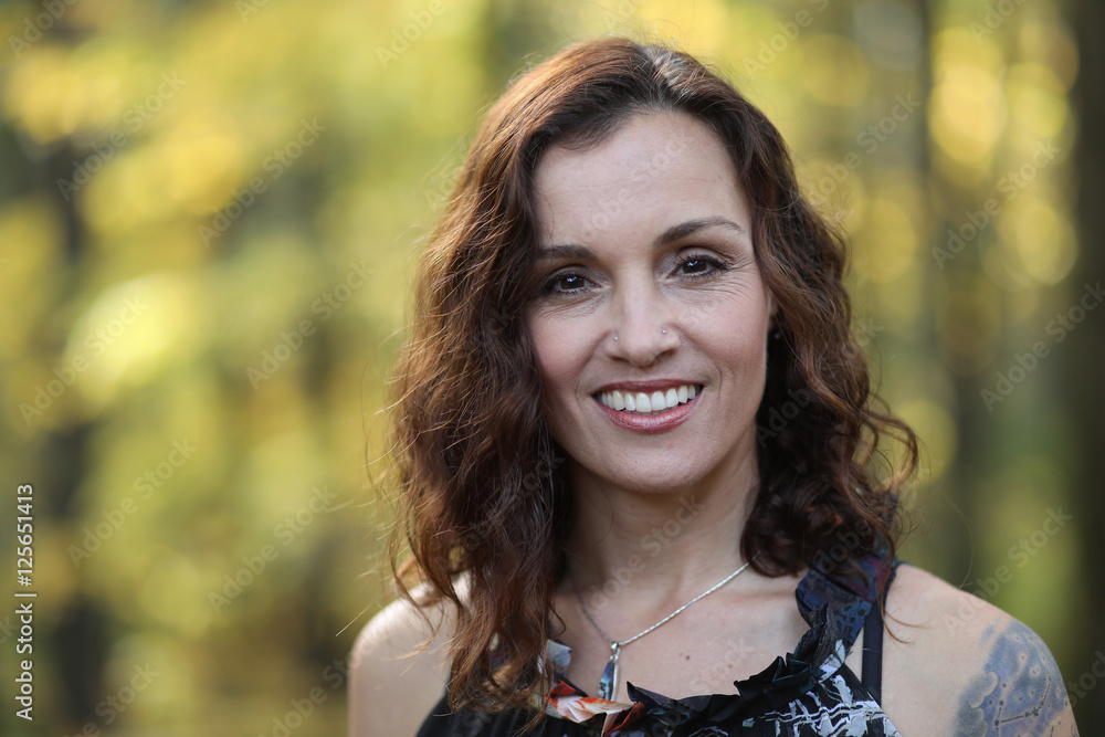 Woman with Brown Hair Against a Fall Background
