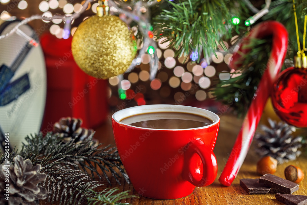 Hot chocolate mug, Christmas tree and gift boxes on background. Traditional sweet winter cocoa drink.