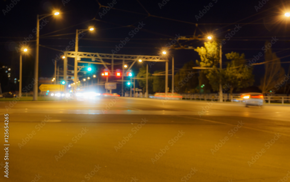 Night intersection, cars, blurred photo