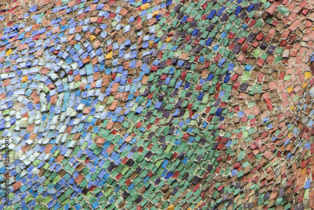 Wall decorated with mosaic tiles and colored bricks Photo execut