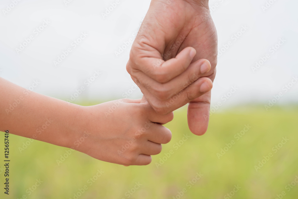 Portrait of Father and daughter holding hand in hand on field. Portrait of Father and daughter holding hand in hand on field.