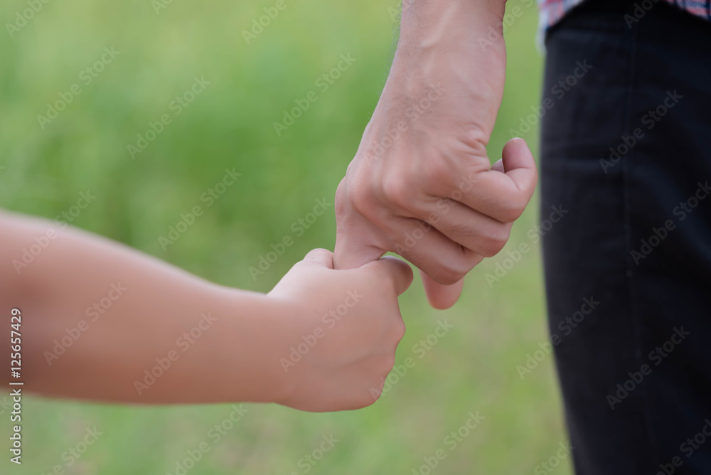 Portrait of Father and daughter holding hand in hand on field. Portrait of Father and daughter holding hand in hand on field.