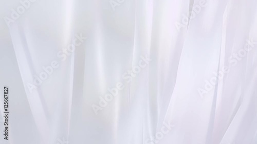 Sheer white curtains blowing in the wind