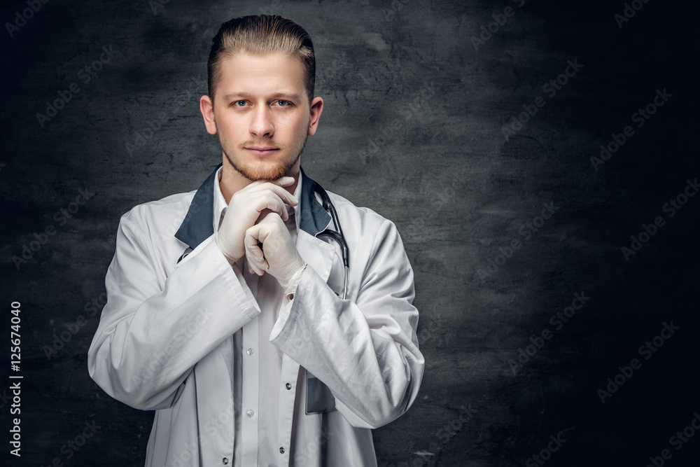 Portrait of confident young medical doctor on grey background. Portrait of confident young medical doctor on grey background.