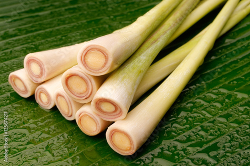 Freshly cut lemongrass arranged on a banana leaf.