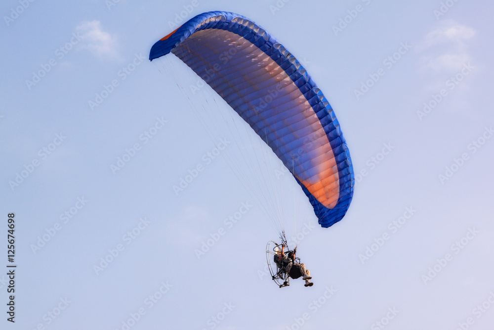 Paragliders flying with paramotor in the clear sky Paragliders flying with paramotor in the clear sky