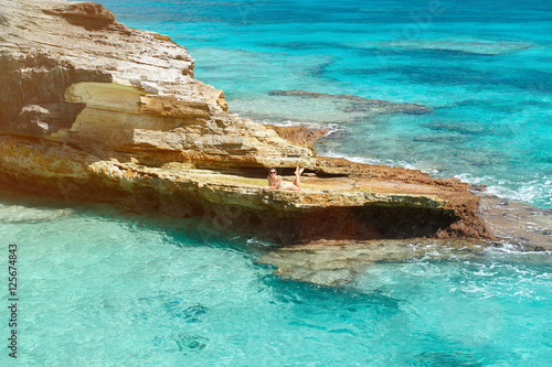 One woman lay on rock