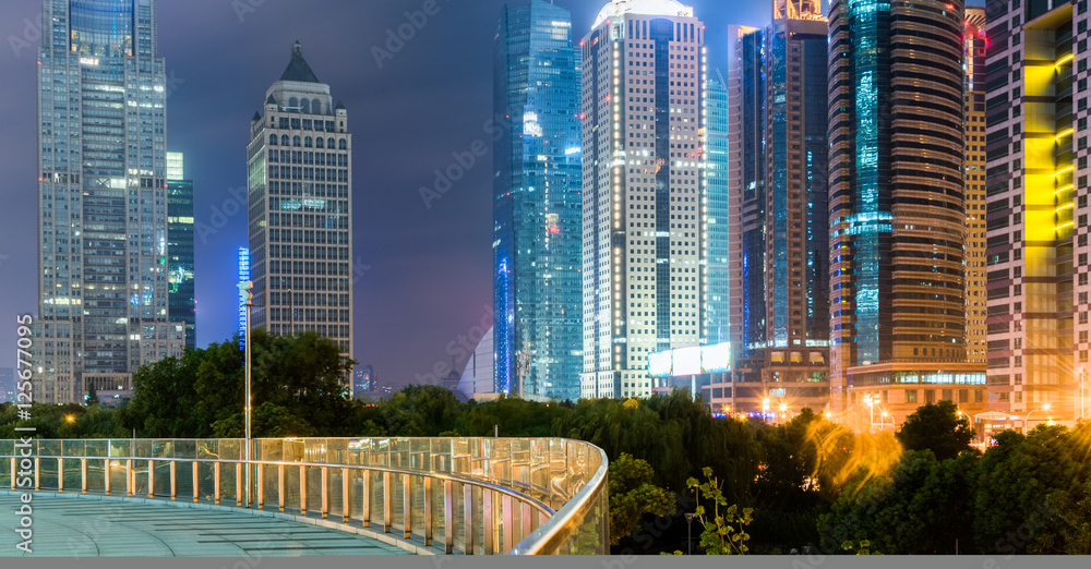 Fototapeta premium footbridge with cityscape at night in Shanghai,China.