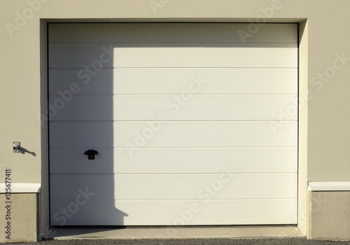 Garage door, half in shadow, half in sunshine.