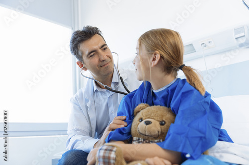 Doctor checking girl in hospital