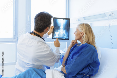 Doctor showing xray to a senior patient in hospital