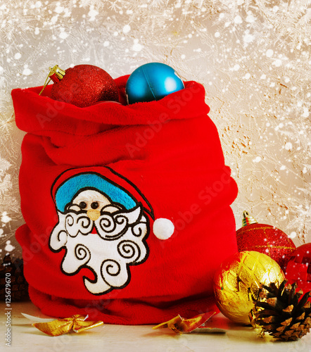 Christmas Composition red and yellow ballsin bag , snowflakes . Vintage style. toning photo