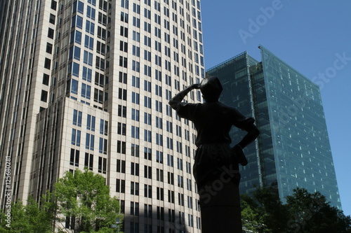 Statue looking over skyscrapers in Downtown Charlotte 