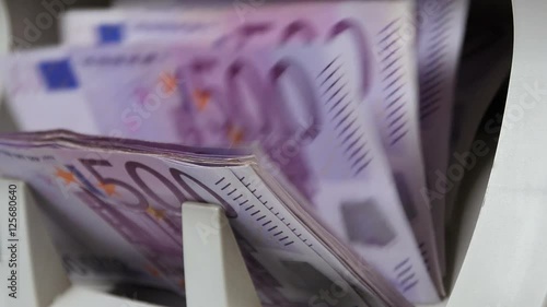 Cash money counting machine. Banknote counter are counting five hundred euro bills.