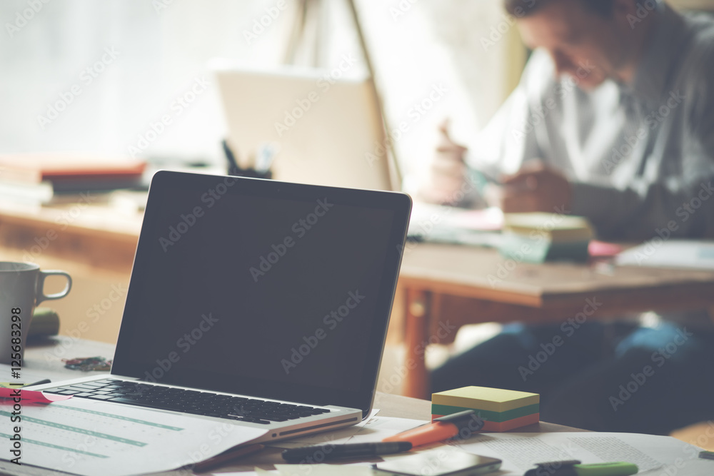 Working day in office. Laptop and paperwork on the table. Manager planning his calendar Working day in office. Laptop and paperwork on the table. Manager planning his calendar