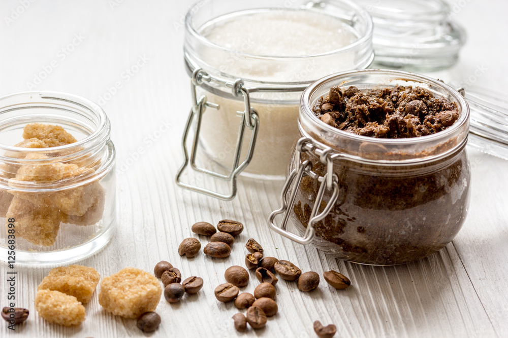 homemade coffe scrub in glass jar on wooden background homemade coffe scrub in glass jar on wooden background