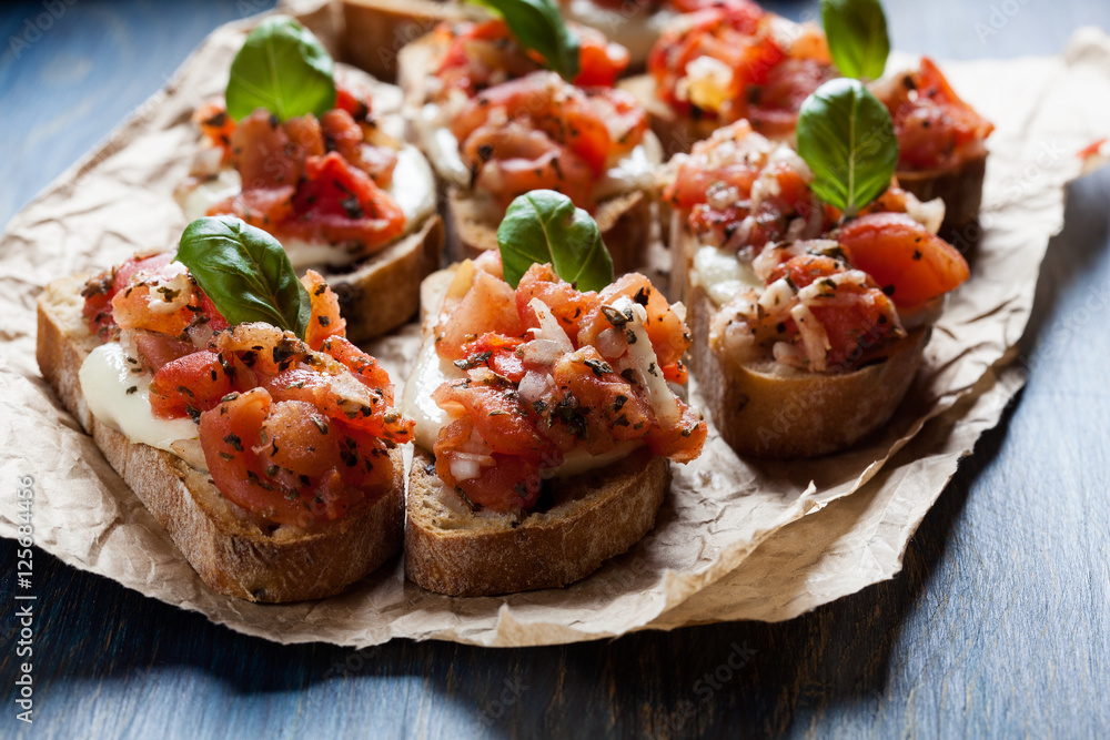Italian bruschetta with roasted tomatoes, mozzarella cheese and Italian bruschetta with roasted tomatoes, mozzarella cheese and