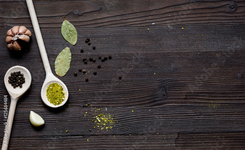 spices in spoon on wooden table top view