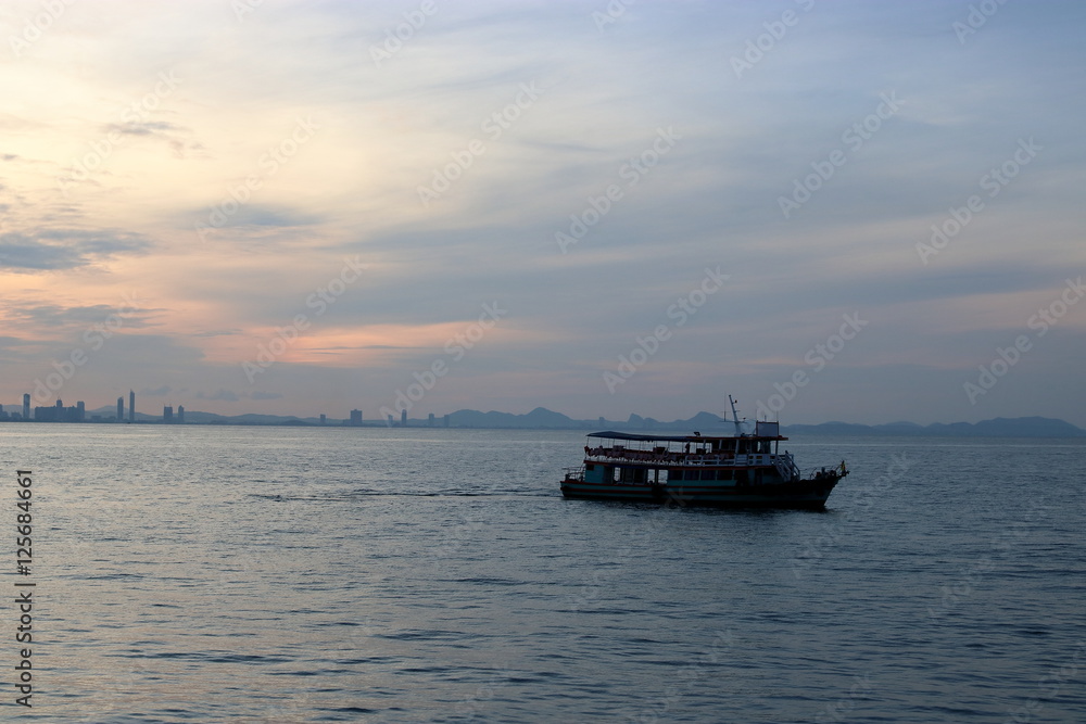 Silhouette of a passenger ferry boat during sunset
