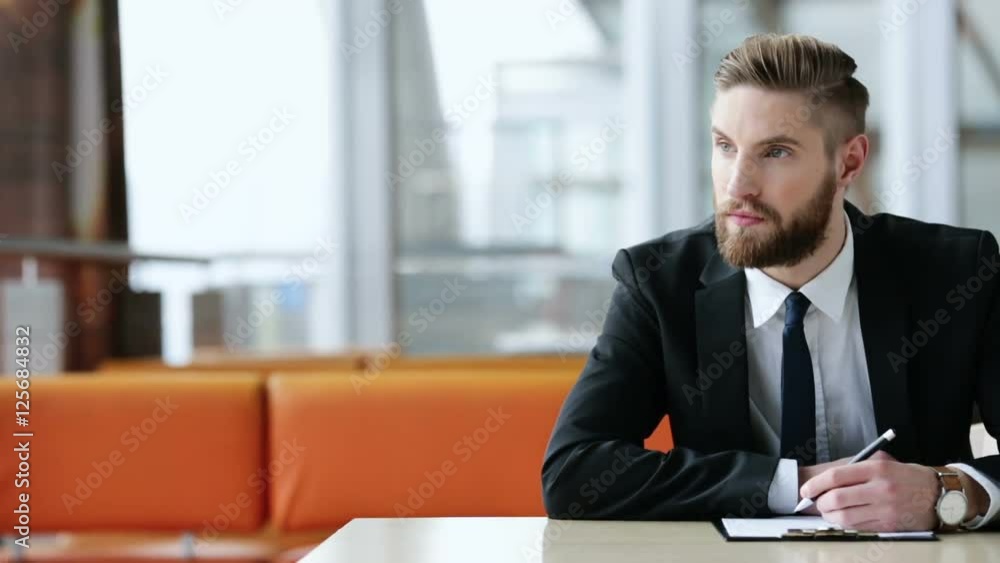 Busy businessman writing down his ideas, plans on paper Busy businessman writing down his ideas, plans on paper