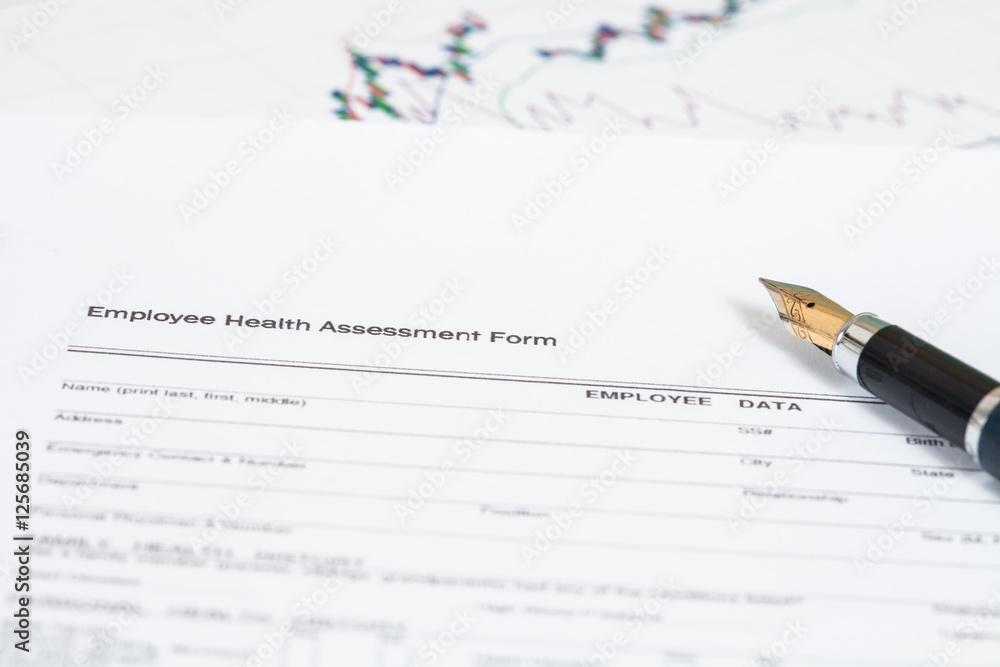 close up employee health assessment form and pen close up employee health assessment form and pen