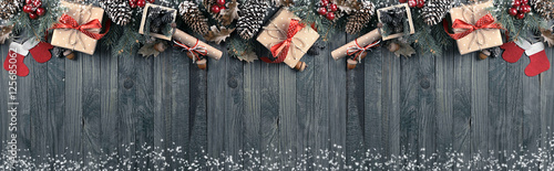 Christmas background with spruce, gift box, Santa Claus boots an