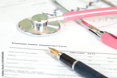 close up employee health assessment form and stethoscope