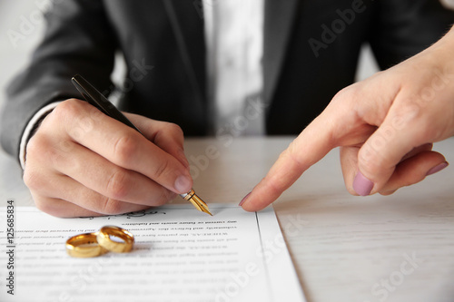 Man signing marriage contract, closeup photo