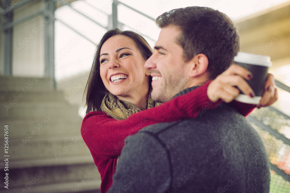 Mixed race couple embracing, smiling and enjoying Mixed race couple embracing, smiling and enjoying