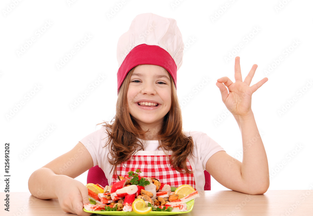 happy little girl cook with seafood and ok hand sign happy little girl cook with seafood and ok hand sign