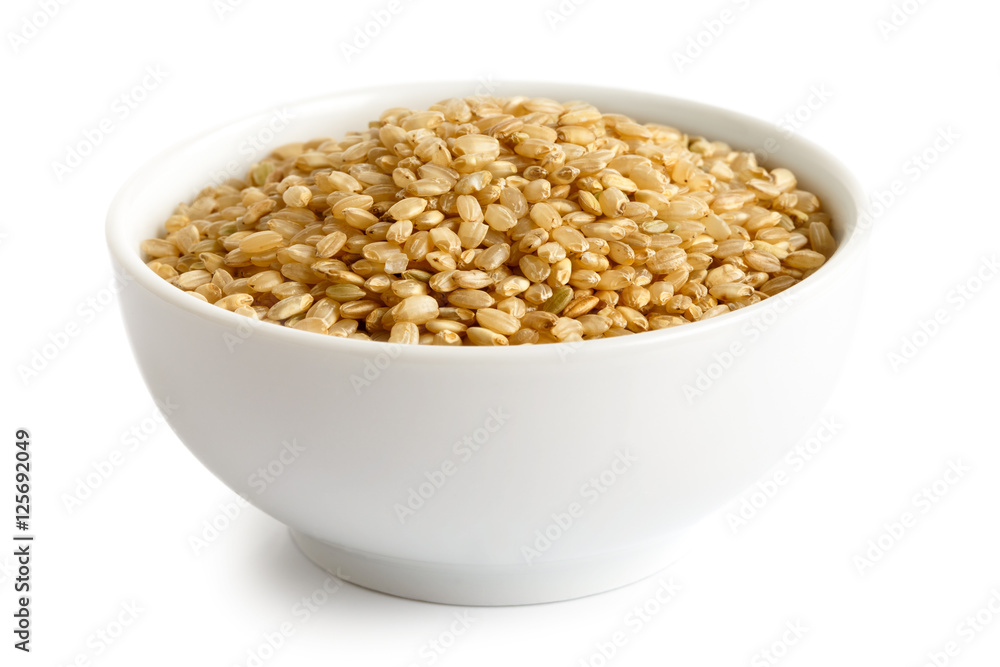 Bowl of short grain brown rice isolated on white. Bowl of short grain brown rice isolated on white.