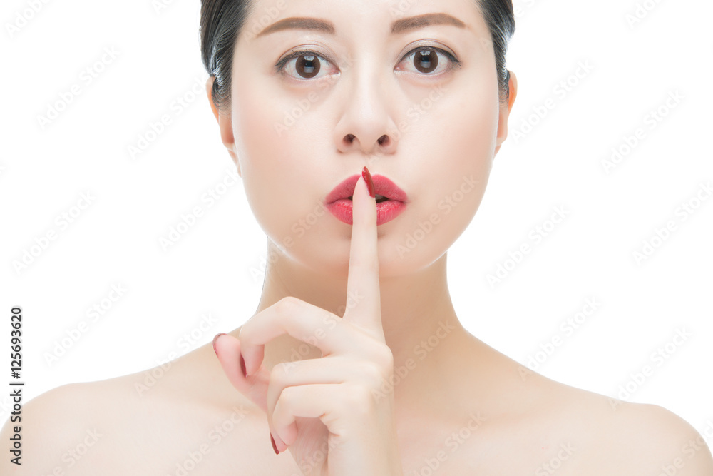 asian woman red lipstick and finger showing hush silence sign asian woman red lipstick and finger showing hush silence sign