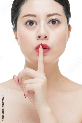 asian woman red lipstick and finger showing hush silence sign