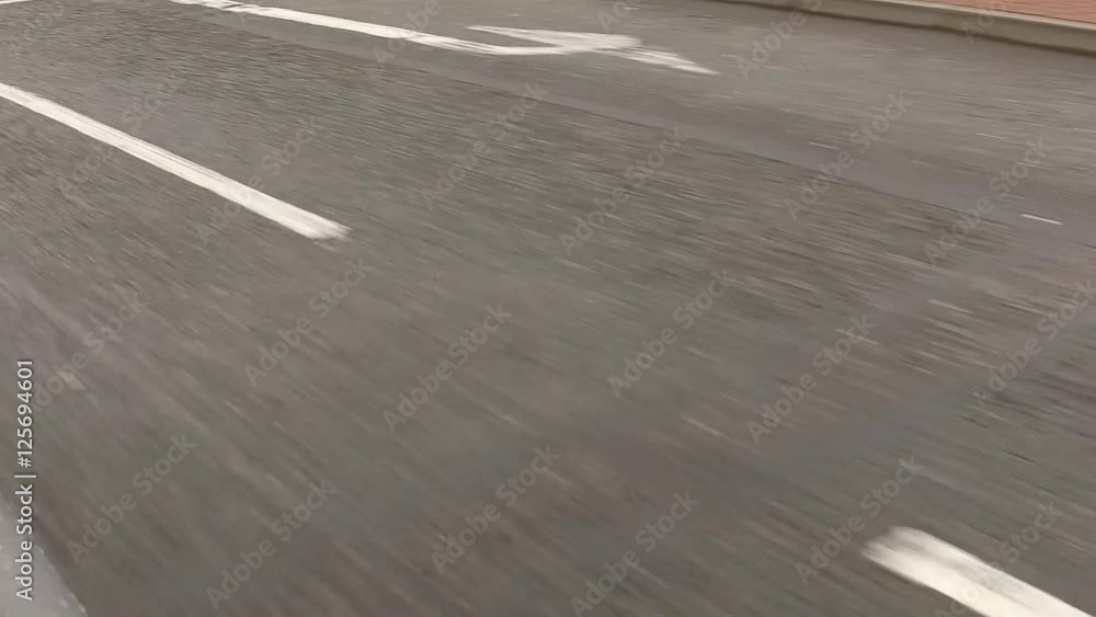 Slow motion shot of a road with white markings.