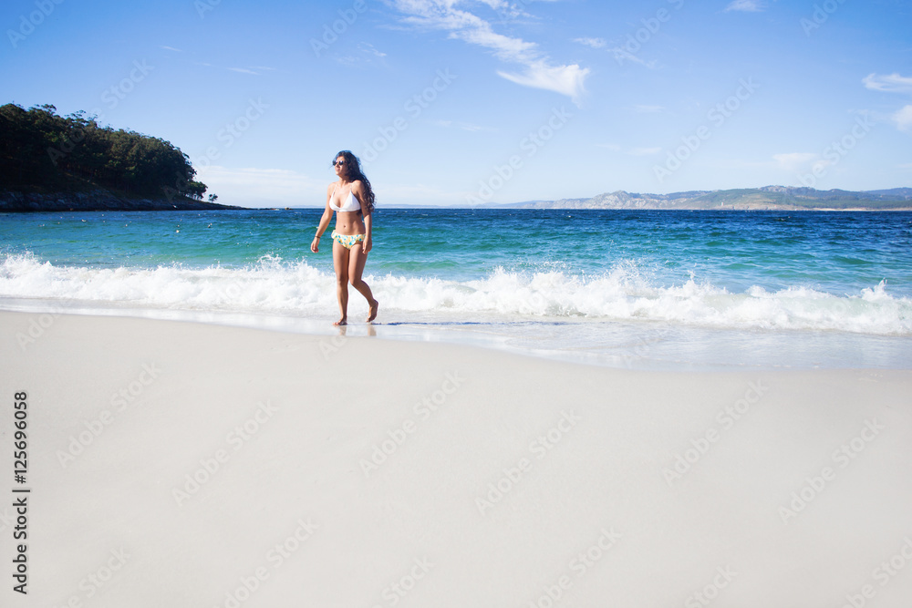 young woman walking in the beach