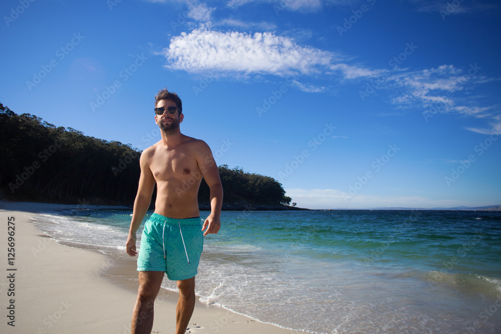 young man walking in the beach