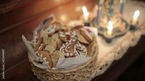 Woman take sweet Christmas cookies from basket photo