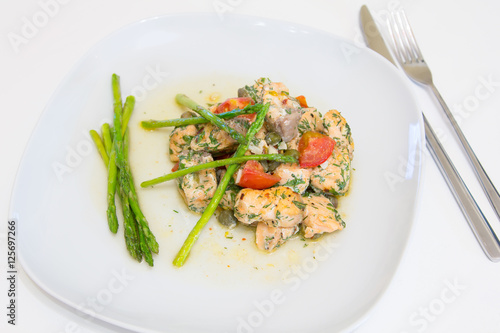Salmon baked with tomato, capers and asparagus
