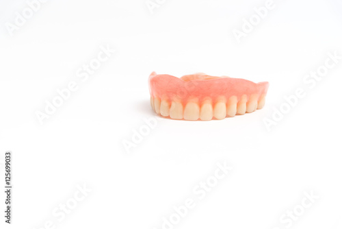 upper dentures on white background